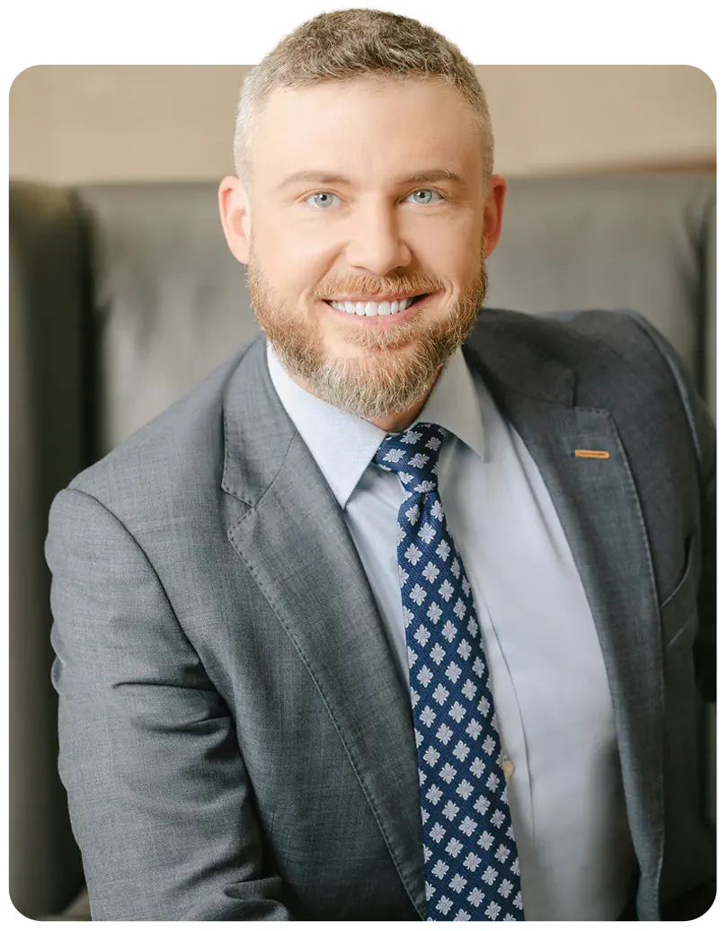 William Eadie, CEO of Eadie Law, smiling while wearing a gray suit
